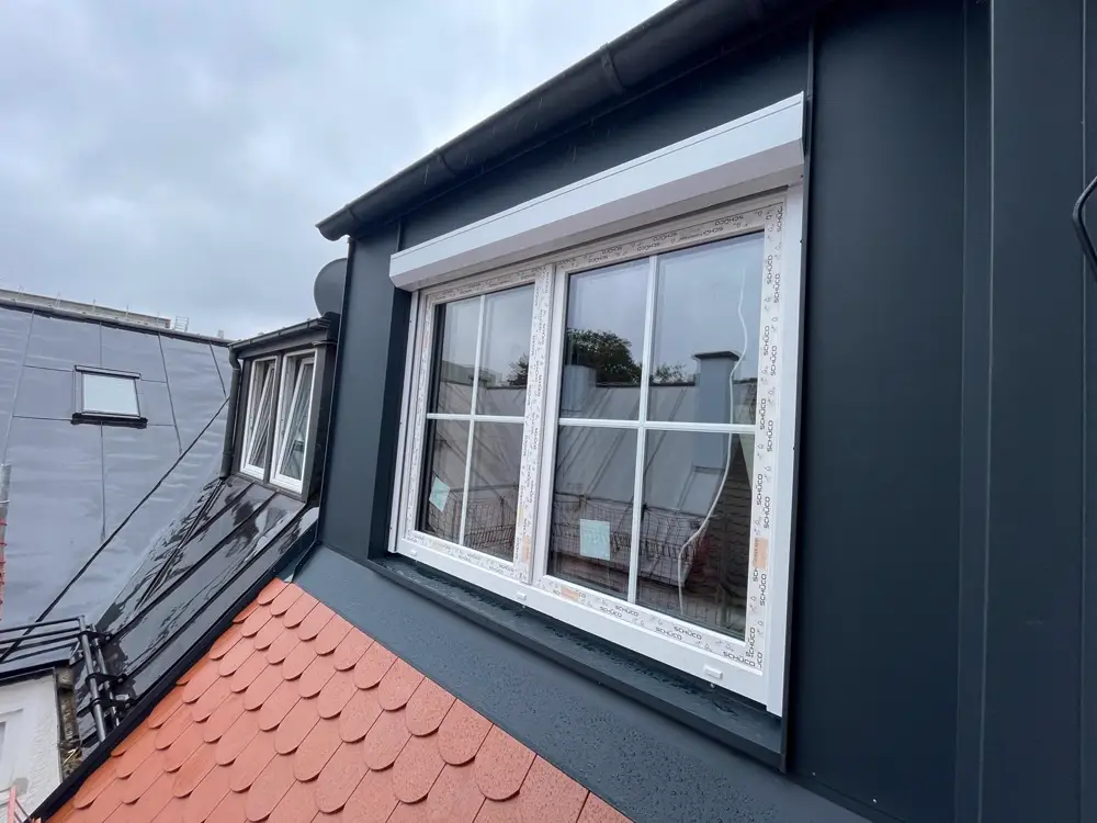 Neu montiertes Dachgauben-Fenster mit Rollladen, Schutzfolie noch am Rahmen